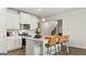 Modern kitchen with an island, stainless steel microwave and gas range, and stylish pendant lighting at 588 Parnassus Road, Locust Grove, GA 30248