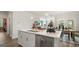 Kitchen island with stainless steel dishwasher, quartz countertop, and barstool seating area at 588 Parnassus Road, Locust Grove, GA 30248