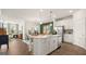Open-concept kitchen featuring a large island, stainless steel appliances, and seamless flow to the dining and living areas at 588 Parnassus Road, Locust Grove, GA 30248