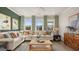 Spacious living room featuring a plush sectional sofa, designer curtains, and natural light at 588 Parnassus Road, Locust Grove, GA 30248