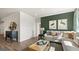 Inviting living room featuring a large sectional sofa, stylish decor, and an open layout at 588 Parnassus Road, Locust Grove, GA 30248