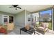 Spacious screened porch with dining and lounge areas, offering views of the landscaped backyard and nearby homes at 588 Parnassus Road, Locust Grove, GA 30248