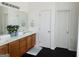 Bright bathroom featuring a double sink vanity with wood cabinets and a large mirror at 13271 Woolsey Rd, Hampton, GA 30228