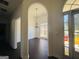 View of entryway with arched doorways, dark floors, and open view to living area at 13271 Woolsey Rd, Hampton, GA 30228