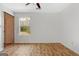 Simple bedroom with vinyl flooring and a large window at 4601 Highway 81 E, Mcdonough, GA 30252