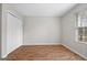 Bedroom with a closet, wood floors, and natural light from a window at 4601 Highway 81 E, Mcdonough, GA 30252