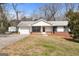 One-story home with brick accents, black shutters and an attached garage in a wooded setting at 4601 Highway 81 E, Mcdonough, GA 30252