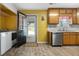 Functional kitchen connected to laundry room with stainless appliances and vinyl flooring at 4601 Highway 81 E, Mcdonough, GA 30252