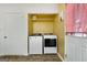 Convenient laundry room features washer, dryer, and built in storage shelves at 4601 Highway 81 E, Mcdonough, GA 30252