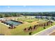 Aerial view shows the neighborhood amenities including tennis courts, dog park and volley ball at 600 Parnassus Rd, Locust Grove, GA 30248