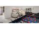 Basement featuring a foosball table, seating area, and elegant lighting fixtures at 600 Parnassus Rd, Locust Grove, GA 30248