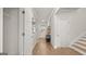 Hallway with hardwood floors and white doors leading to various rooms in the home at 600 Parnassus Rd, Locust Grove, GA 30248