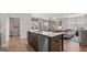 Kitchen island overlooking dining room and the living room with quartz counter top, stainless steel appliances at 600 Parnassus Rd, Locust Grove, GA 30248