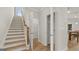 Well-lit staircase with wood treads and white risers leading to the upper level of the home at 600 Parnassus Rd, Locust Grove, GA 30248