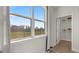 Bright room showcasing view of the outdoors through a large window, next to the large storage closet at 600 Parnassus Rd, Locust Grove, GA 30248