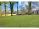 Large backyard with mature trees, a well-kept lawn, and privacy fencing at 2594 Cavalier Dr, Decatur, GA 30034