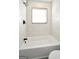 Bathtub with updated fixtures and marble look tile surround at 2594 Cavalier Dr, Decatur, GA 30034