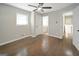 Spacious bedroom with hardwood floors, natural light from a window, and a glimpse of the en-suite bathroom at 2594 Cavalier Dr, Decatur, GA 30034