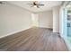 Bedroom features wood-look vinyl flooring, ceiling fan, large slider to backyard, and ensuite door at 2594 Cavalier Dr, Decatur, GA 30034