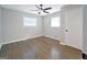 A bright bedroom featuring hardwood floors, a window providing ample natural light, and neutral-colored walls at 2594 Cavalier Dr, Decatur, GA 30034