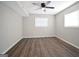 Empty bedroom with ceiling fan, vinyl flooring, and two bright windows at 2594 Cavalier Dr, Decatur, GA 30034