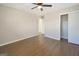 Spacious bedroom with hardwood flooring, a ceiling fan, and a large closet at 2594 Cavalier Dr, Decatur, GA 30034