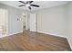 Neutral-colored primary bedroom with hardwood floors, a ceiling fan, closet, and ensuite bathroom door at 2594 Cavalier Dr, Decatur, GA 30034