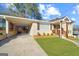 Charming brick home featuring a well-manicured lawn, covered parking, and a welcoming front porch at 2594 Cavalier Dr, Decatur, GA 30034