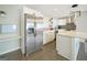 Bright kitchen features stainless steel refrigerator, white cabinets, island with countertops, and hardwood floors at 2594 Cavalier Dr, Decatur, GA 30034