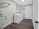 Bright laundry room with washer, dryer, overhead lighting, and wood-look flooring at 2594 Cavalier Dr, Decatur, GA 30034