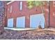 View of the home's three-car garage showing brick facade and white doors at 219 Eagles Landing Way, Mcdonough, GA 30253