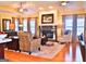 Spacious living area showcasing a stone fireplace, comfortable seating, and hardwood flooring at 219 Eagles Landing Way, Mcdonough, GA 30253