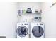 Well-organized laundry room featuring modern washer and dryer units with ample shelving for storage of supplies at 305 Beavers Rd, Grantville, GA 30220