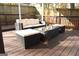 Cozy backyard patio area featuring wicker furniture, a glass-top coffee table, and comfortable cushioned seating at 1103 Coleman Sw St, Atlanta, GA 30310