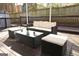 Backyard patio area featuring wicker furniture, a glass-top coffee table, and comfortable cushioned seating at 1103 Coleman Sw St, Atlanta, GA 30310