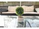 Backyard patio area with a decorative plant on a glass table and a cushioned wicker sofa for outdoor relaxation at 1103 Coleman Sw St, Atlanta, GA 30310