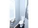 Cozy bathroom with wood-look floors, a toilet, and a wire basket holding toilet paper rolls at 1103 Coleman Sw St, Atlanta, GA 30310