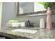 Bathroom vanity with granite countertop, decorative mirror, and stylish accessories at 1103 Coleman Sw St, Atlanta, GA 30310