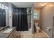 Bathroom featuring granite countertops, tiled flooring, and a shower with a tiled enclosure and dark fixtures at 1103 Coleman Sw St, Atlanta, GA 30310