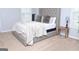 Bedroom with a stylish upholstered bed frame, soft carpeting, and a bedside table with a lamp at 1103 Coleman Sw St, Atlanta, GA 30310