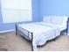 Bedroom with blue walls, a large window, and a full-sized bed with blue comforter and pillows at 1103 Coleman Sw St, Atlanta, GA 30310