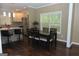 Bright dining area boasts a large window, modern lighting, and dark hardwood floors at 1103 Coleman Sw St, Atlanta, GA 30310