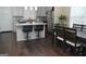 Eat-in kitchen with granite countertops, tile backsplash, stainless appliances, and dark hardwood flooring at 1103 Coleman Sw St, Atlanta, GA 30310