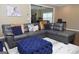 Open layout, large sectional with accent pillows, and a blue tufted ottoman at 1103 Coleman Sw St, Atlanta, GA 30310