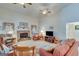 Spacious living room with a stone fireplace, ceiling fans, and large windows for ample natural light at 4623 Mulberry Fields, Auburn, GA 30011