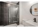 Modern bathroom featuring a glass shower, updated sink, and a round mirror at 425 Meadowbrook Dr, Mcdonough, GA 30253