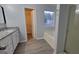 Bathroom with granite countertops, gray flooring, shower, bathtub, and view of the outdoors at 3355 Brookside Ln, Jonesboro, GA 30236