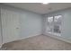 Neutral bedroom featuring carpet flooring and a large window at 3355 Brookside Ln, Jonesboro, GA 30236