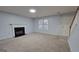 Living room featuring a fireplace, neutral paint, plush carpet, staircase, and natural lighting at 3355 Brookside Ln, Jonesboro, GA 30236