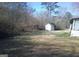 Overgrown backyard with shed and foliage needs maintenance at 735 Oglesby Bridge Se Rd, Conyers, GA 30094